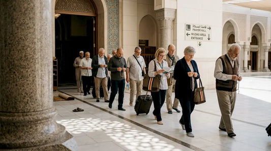 Pilgrims walk past mosque entrance with prayer beads